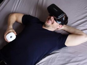 man in black tank top lying on bed