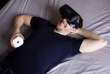 man in black tank top lying on bed