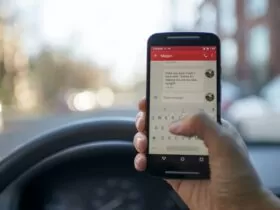 Person Sitting Inside Car With Black Android Smartphone Turned on