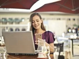 Woman Wearing Purple Shirt Holding Smartphone White Sitting on Chair