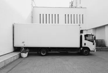 white truck parked near white building