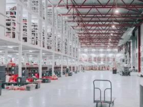 people sitting on red and white chairs inside building