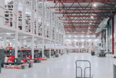 people sitting on red and white chairs inside building