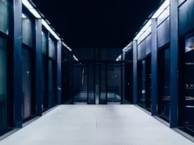 a long hallway with glass doors leading to another room