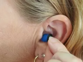 woman wearing blue stud earring