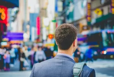 shallow focus photography of man in suit jacket's back